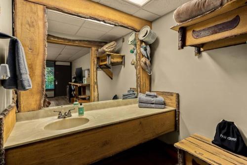 a bathroom with a sink and a mirror at Stonegate Lodge King Bed WIFI 50 in Roku TV Salt Water Pool Room # 101 in Eureka Springs