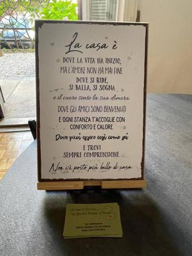 a sign with a menu on top of a table at La Casa di Brunina - Sentirsi a casa - Con garage auto in Monza