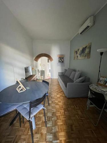 a living room with a couch and a table at La Casa di Brunina - Sentirsi a casa - Con garage auto in Monza