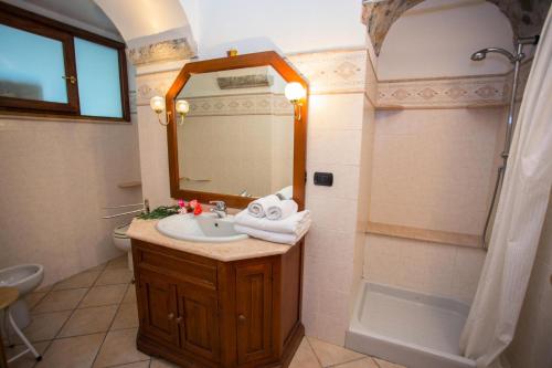 ein Badezimmer mit einem Waschbecken, einem Spiegel und einer Badewanne in der Unterkunft Résidence Rue Longue - Pièces 694 in Menton