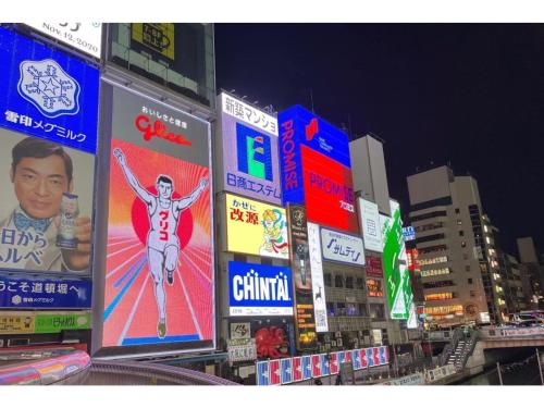 a group of signs on buildings in a city at Eslead Hotel Namba South III - Vacation STAY 39775v in Osaka