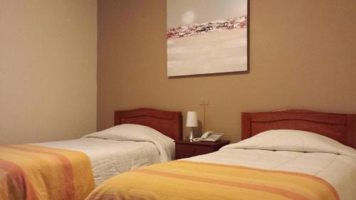 Кровать или кровати в номере Belle Sand Hotel