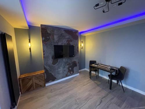 a room with a desk and a tv on a wall at 1bedroom ground floor apartment in Aberdeen