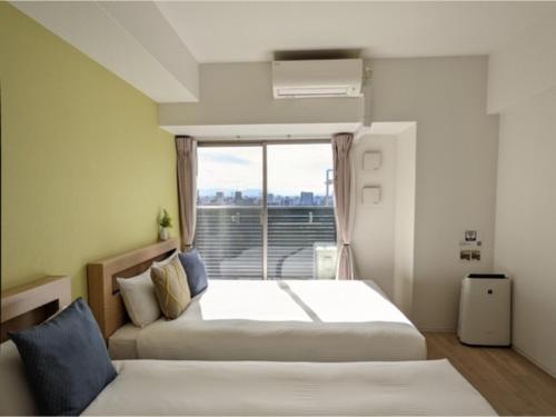 Giường trong phòng chung tại Eslead Hotel Namba South III - Vacation STAY 39771v