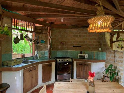 a kitchen with a sink and a stove top oven at Casa Komerio in Palomino