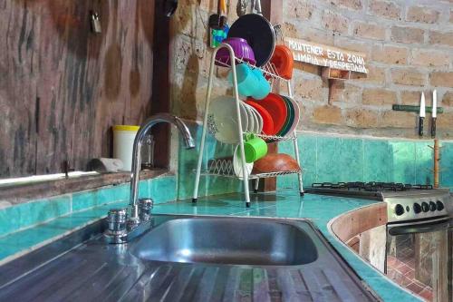 a kitchen counter with a sink and a stove at Casa Komerio in Palomino