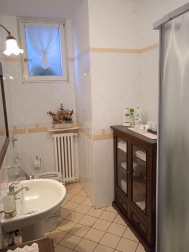 La salle de bains est pourvue d'un lavabo, de toilettes et d'une fenêtre. dans l'établissement LA MAGNOLIA 2.0, à Candelo