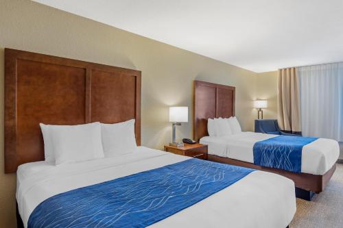 a hotel room with two beds and two lamps at Comfort Inn & Suites Rocklin in Rocklin