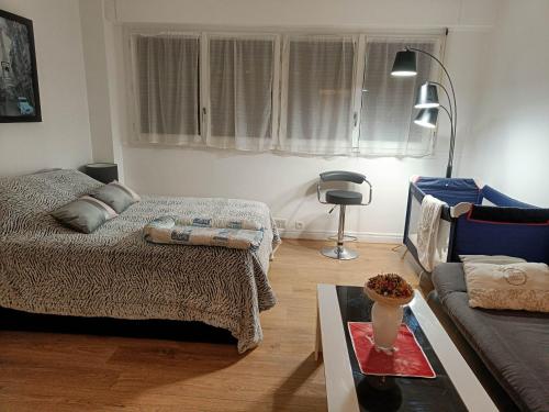 un salon avec un lit et un canapé dans l'établissement La perle d'Alesia, à Paris