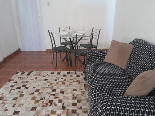 a living room with a couch and a table with chairs at studio in Rio de Janeiro