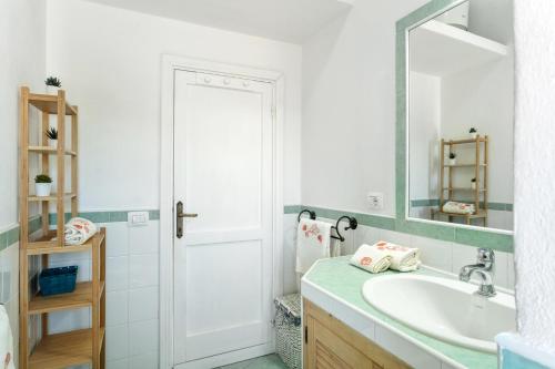 a bathroom with a sink and a mirror at Vista mozzafiato fronte mare in Olbia