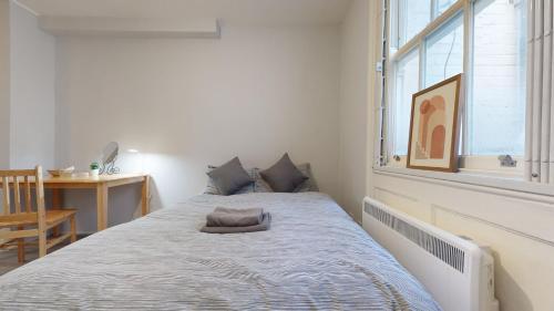 a bed in a room with a large window at Lovely 1 double bed Studio in Marylebone in London