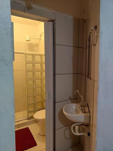 a small bathroom with a toilet and a sink at Cantinho das Olandas in Olinda