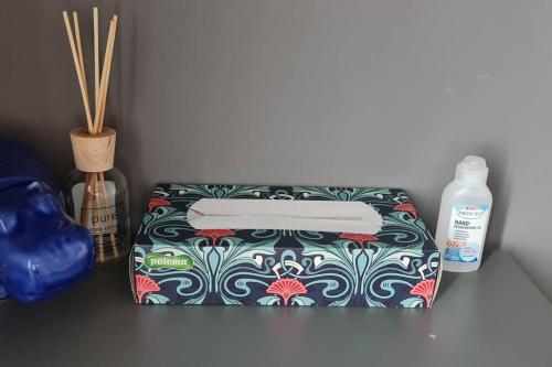 a colorful box sitting on a table with a bottle of soap at Apartment Obi Osijek in Osijek