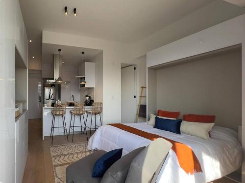 a large bedroom with a large bed and a kitchen at Chic 1BR Loft in the Heart of Roma Norte in Mexico City