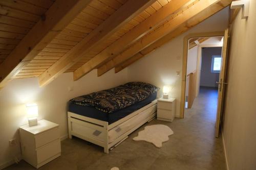 a bedroom with a bed and two night stands at Maisonnette de campagne in Sion