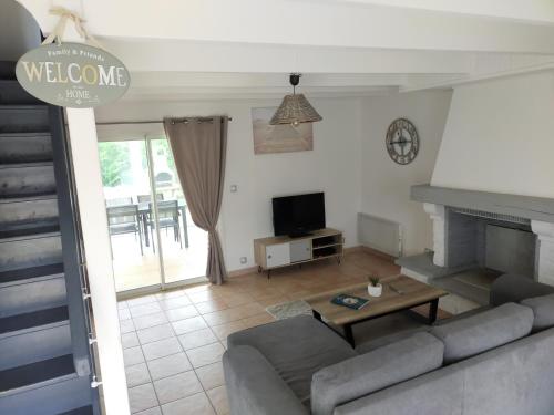 a living room with a couch and a table at La Longère de Fréd et Line in La Garnache