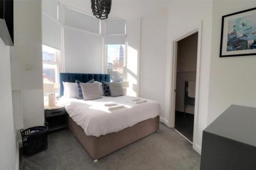a bedroom with a bed and a large window at Sound of the Sea - Ilfracombe in Ilfracombe