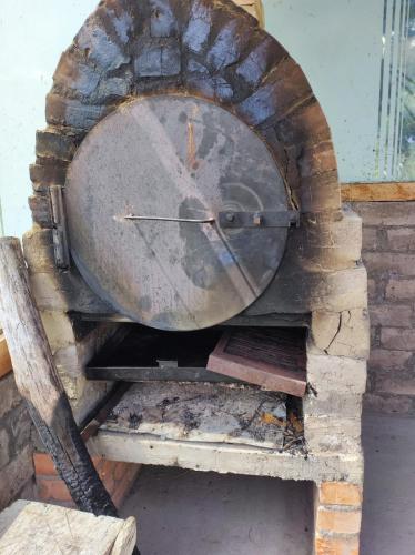 a brick oven with a clock on top of it at Finca Buenos aires in Oicatá