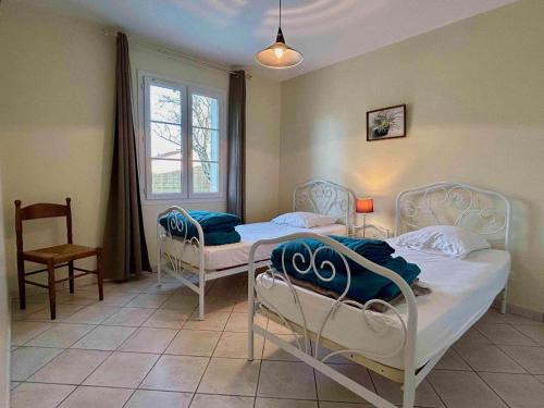 1 dormitorio con 2 camas, silla y ventana en Maison Dolus-d'Oléron, 4 pièces, 6 personnes - FR-1-246A-158, en Dolus d'Oléron