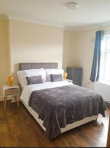 a bedroom with a large bed and a window at Gravesend 1 Bedroom Flat 2 Min Walk to Station & Town Centre in Kent