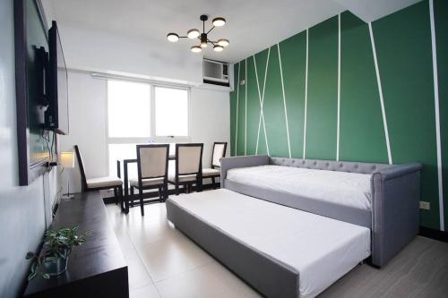 a bedroom with a bed and a table and chairs at Home w/ City View - Pool + Fast Wifi 3016 in Manila