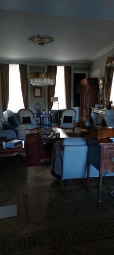 a living room with couches and chairs in it at La Guériniere la Moulidart in Châteauneuf-sur-Charente