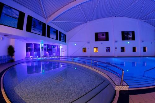a large swimming pool in a building at Snowdrop Cottage in Seahouses