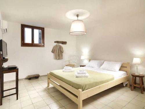 a bedroom with a bed with towels on it at Villa Hermes - Luxury Villa Paros in Kampos Paros