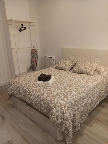 a bedroom with a bed with a comforter on it at Gregorio Marañón Apartment4 in Madrid