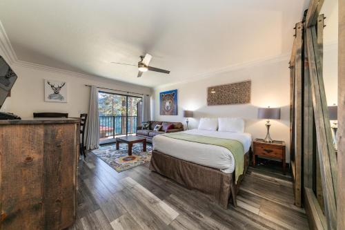 a bedroom with a bed and a living room at Striking King Studio w/Partial Lake View #242 at Donner Lake Village in Truckee