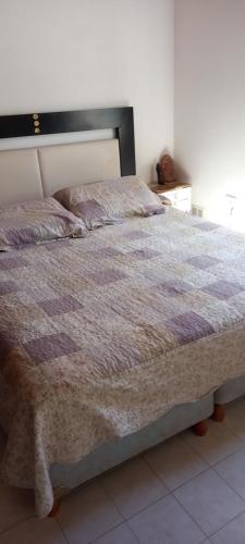 a large bed in a bedroom with at Alojamiento Zen in Puerto Madryn