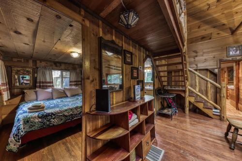 a bedroom in a tree house with a bed and stairs at Two Bedroom Cabin Used To Belong to Deborah Winger! in Ruidoso
