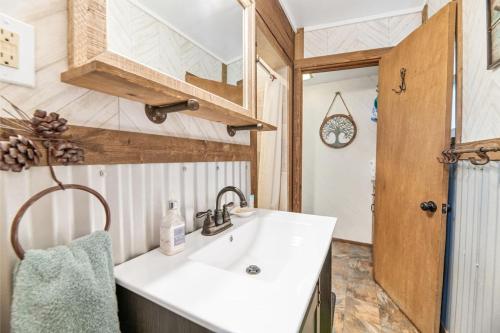 a bathroom with a sink and a mirror at Hansel and Gretel Cottage in Big Bear City