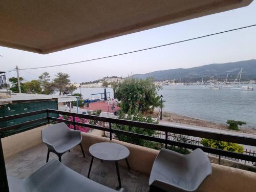 a balcony with chairs and a view of the water at Irene Vìlla in Poros