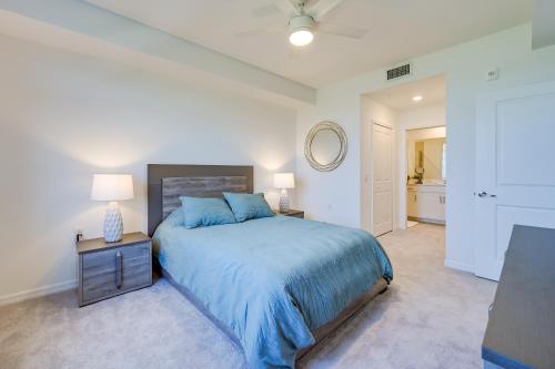 a bedroom with a blue bed and a mirror at Breezy Ave Maria Condo with Golf Course On-Site! in Harker