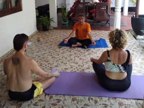 - deux personnes assises sur un tapis de yoga violet dans l'établissement Dream Forest Rest, à Ahangama