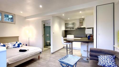 un salon avec un lit et une cuisine dans l'établissement Les Ecureuils Du Parc à 400 m de la plage, à Royan