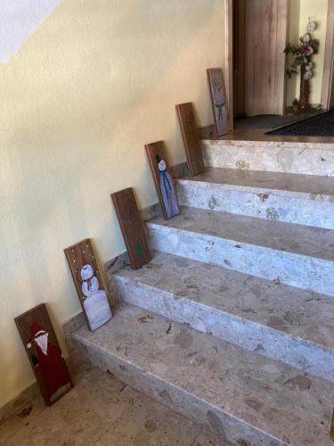 a set of stairs with pictures on them at Ferienwohnung Alte Feuerwehr in Feistritz ob Bleiburg