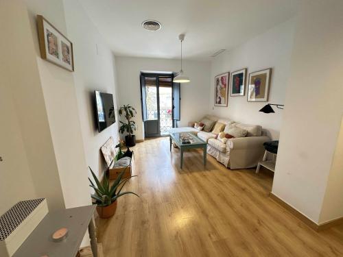 a living room with a couch and a table at Alma de San Bernardo in Seville