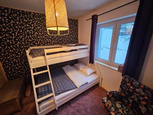 a bunk bed with a ladder in a room at Willa Szewcula Apartament Skrzyczne in Szczyrk