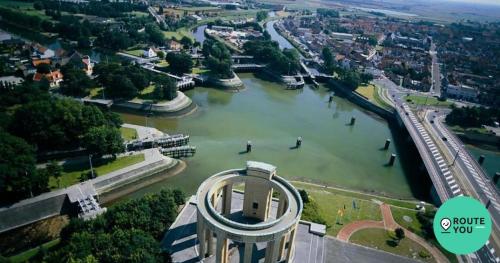 a view of a river with a bridge and a city at Dream@coast in Nieuwpoort