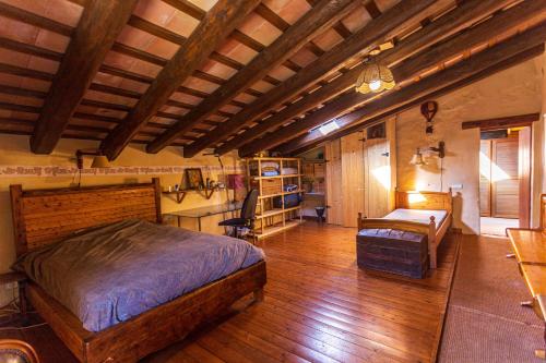 um quarto com 2 camas num quarto com pisos em madeira em Masia Paradise em Llinars del Vallès
