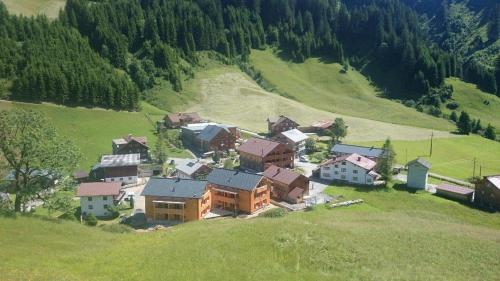 an aerial view of a house on a hill at Alpin Chalet Schröcken in Schröcken
