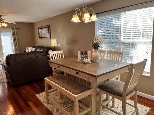 a dining room with a wooden table and chairs at Log Bunk Bed, Playhouse, & TeePee-Willow Trace Retreat 5mi to Dollywood in Sevierville
