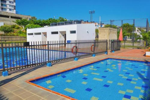 a large swimming pool in front of a building at Chic 2Bedroom in Cúcuta in Villa del Rosario
