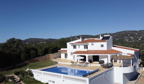 a large white house with a swimming pool at Villa Casa Colina - Algarve - 7 Bedrooms, Private location in Estói