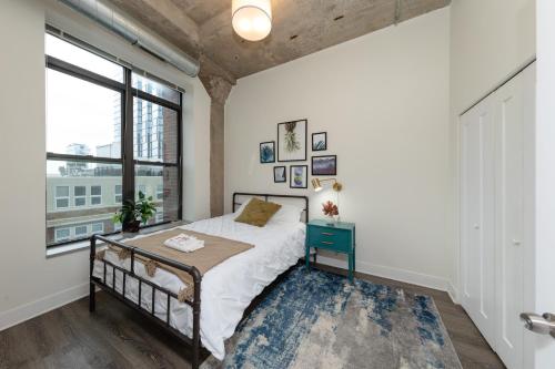 a bedroom with a bed and a large window at McCormick Place 2b-2b family unit with optional parking sleeps up to 6 in Chicago