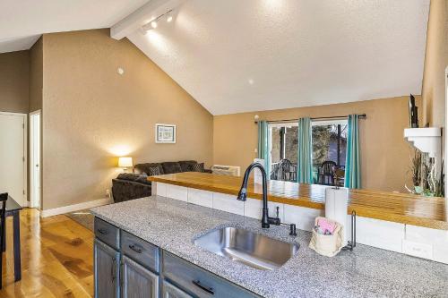 a kitchen with a sink and a living room at Ship Dock Lane A in Osage Beach