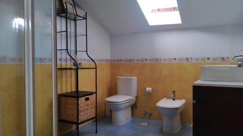a bathroom with a toilet and a sink at CASA IRIANA - Chimenea I Jardín I Barbacoa in Ourense